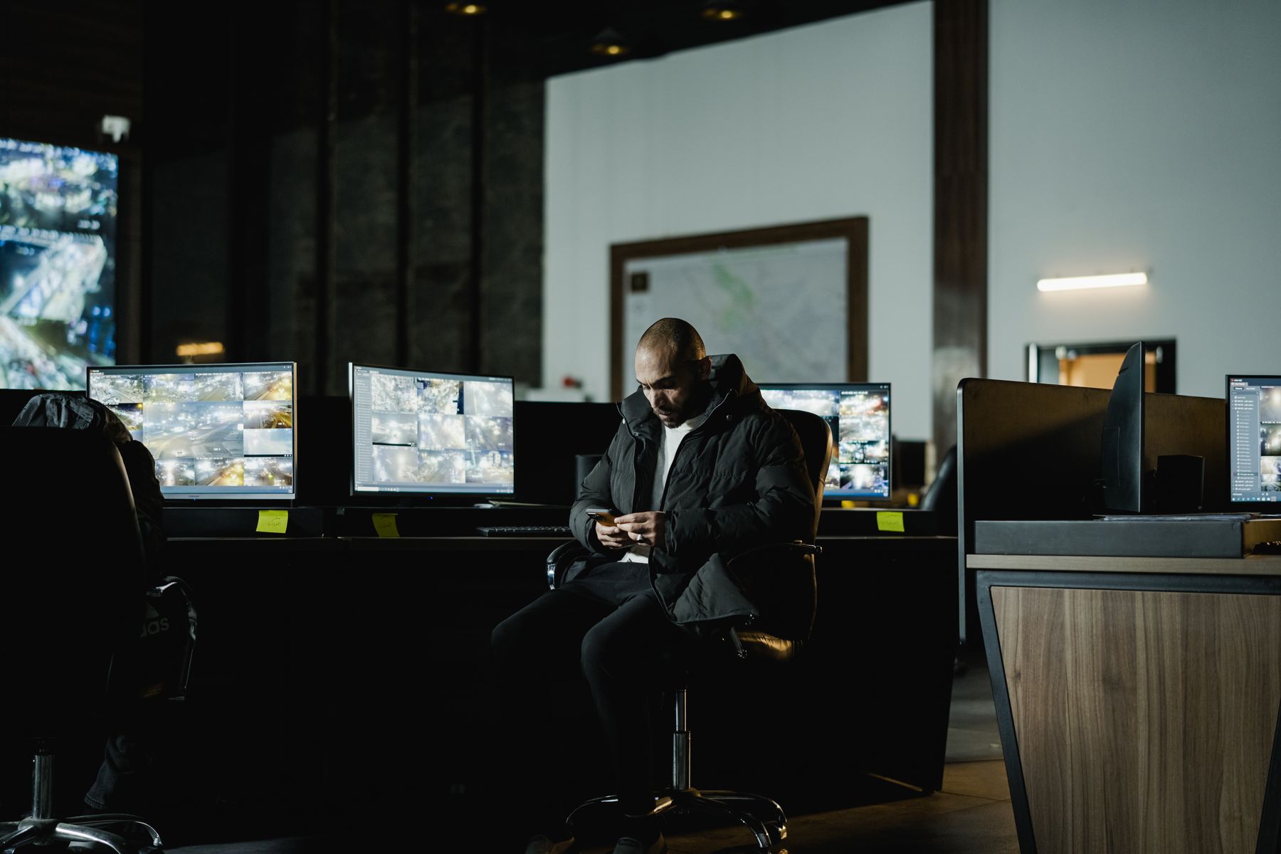 Security professional working in a surveillance operations room